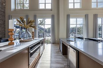 a large kitchen with large windows and a large counter top at The Monroe Apartments, Austin, Texas